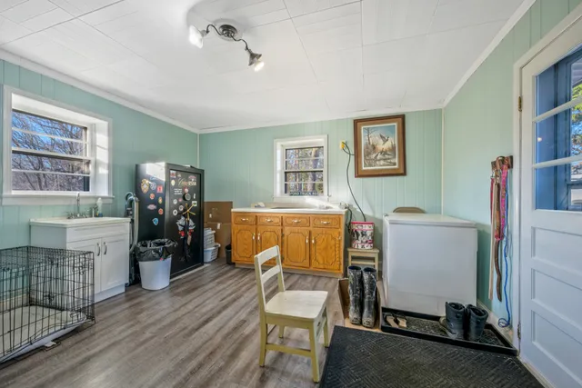 a room with furniture a air conditioner vent and a window