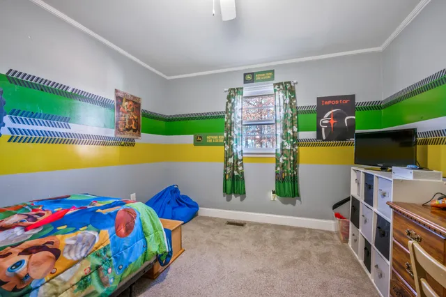 a bedroom with a bed and a view of kitchen