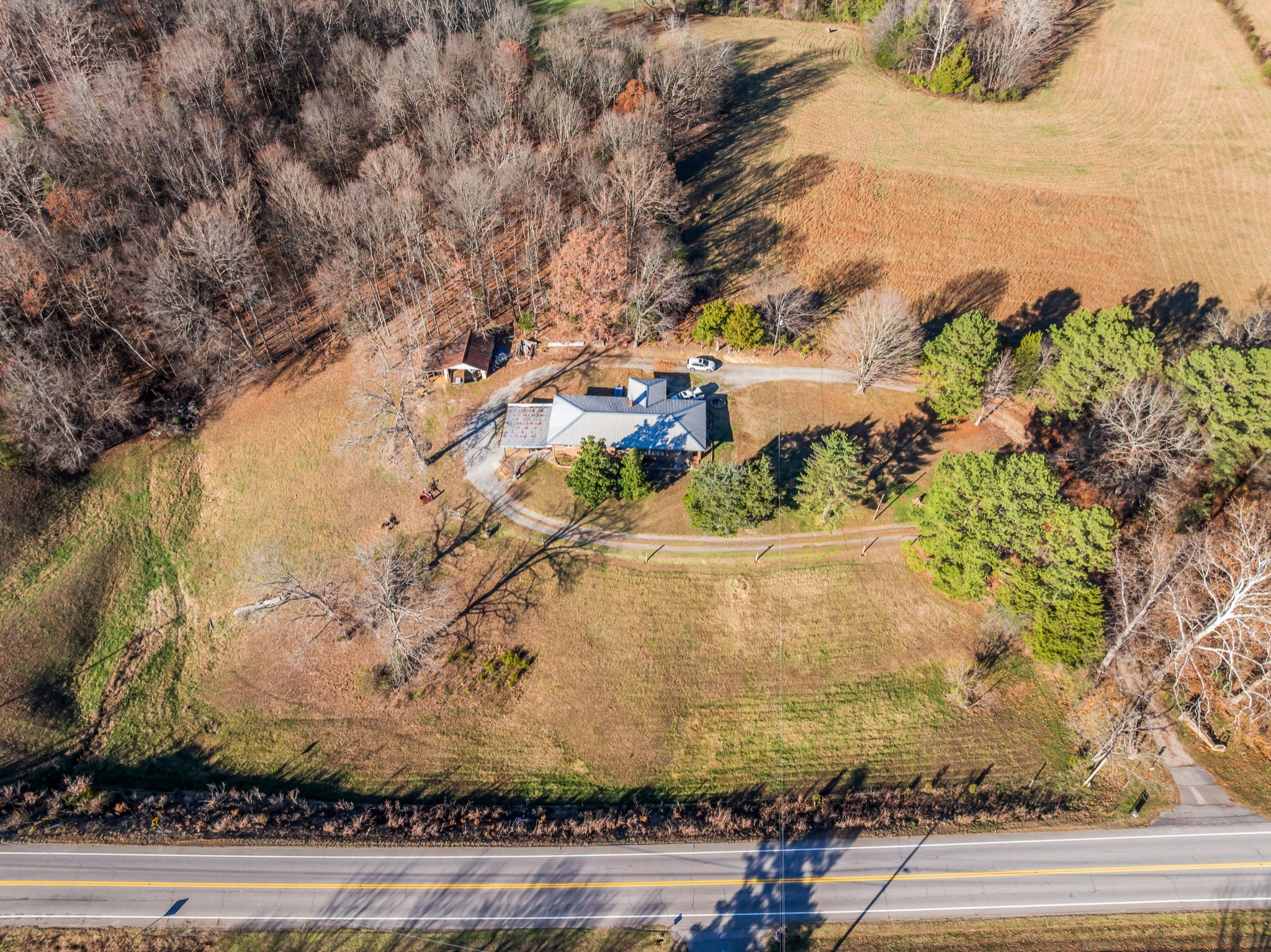 1555 Highway 13 Cunningham, TN 37052 - Photo 4 of 30 a view of a yard with cars parked on the road