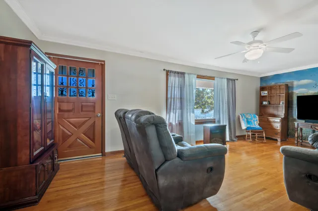 a living room with furniture a flat screen tv and a window