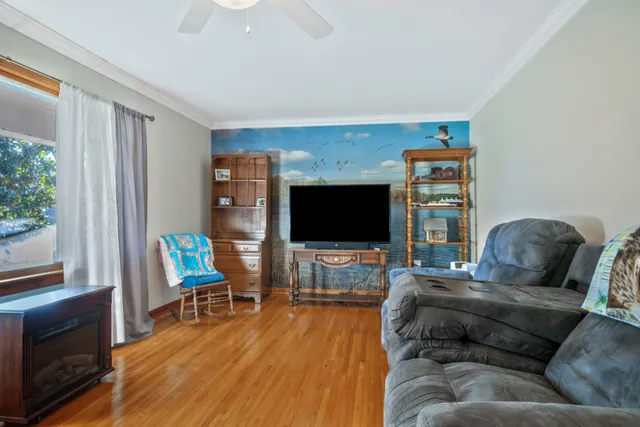 a living room with furniture and a flat screen tv