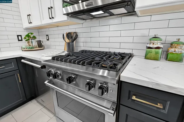 a stove top oven sitting inside of a kitchen