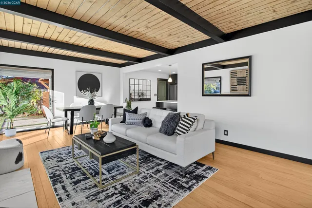 a dining room with furniture and wooden floor