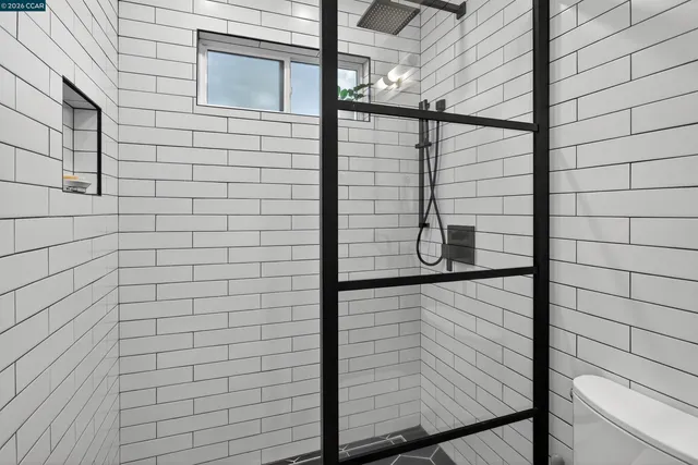 a bedroom with a bed and a large window