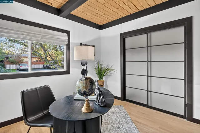 a bed sitting in a bedroom next to a window