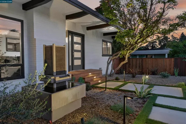 a view of a house with backyard and sitting area