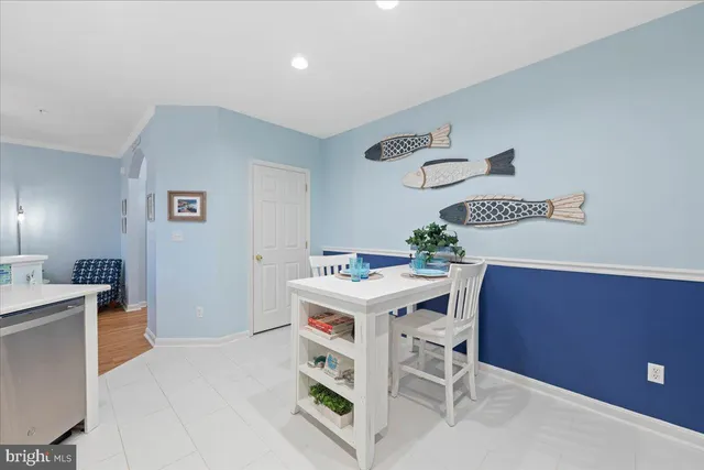 a view of a kitchen with cabinets and wooden floor