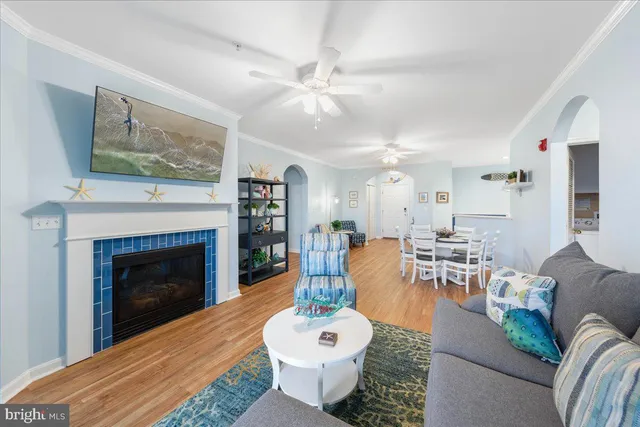 a living room with furniture a chandelier and a fireplace
