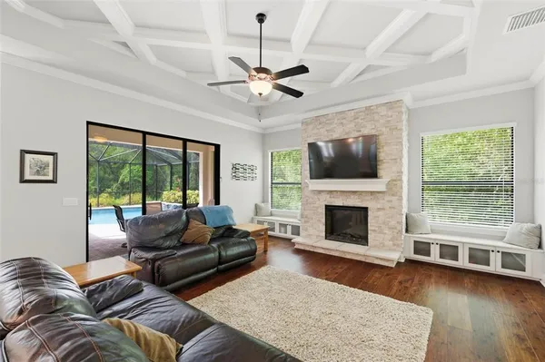 a living room with furniture tv and a fireplace