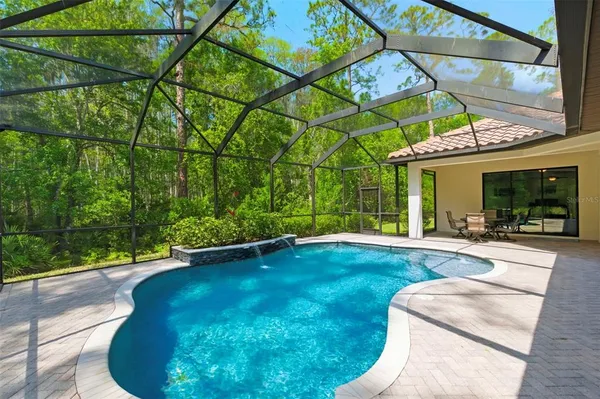 a view of a house with backyard sitting area and tub