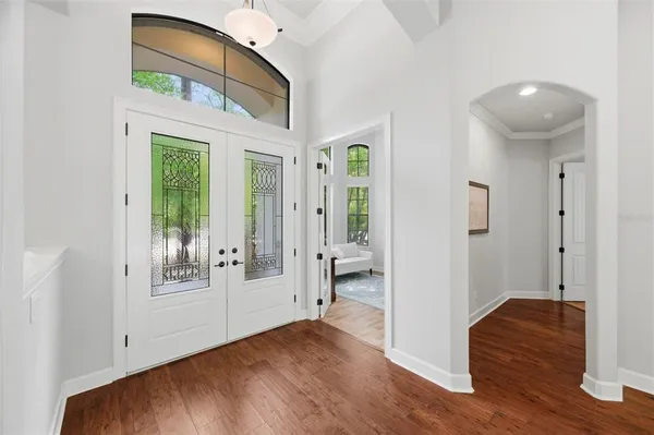 a view of an entryway with wooden floor and door