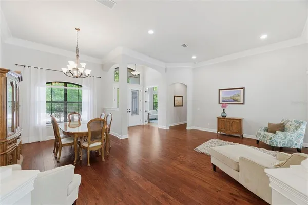 a living room with furniture and a chandelier