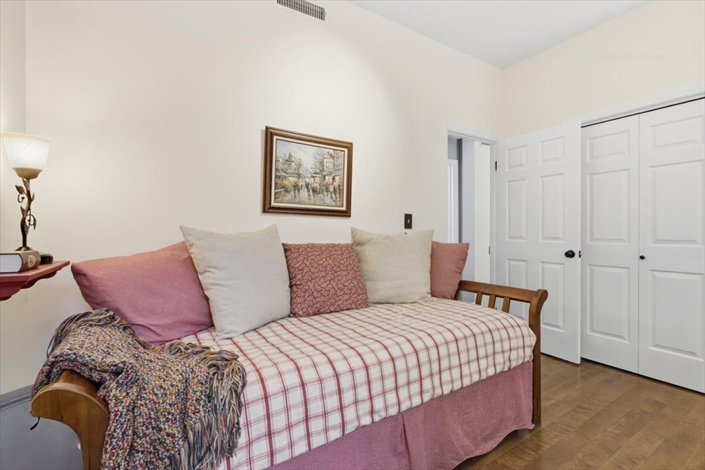65 Glen Road, Unit H1 Brookline, MA 02445 - Photo 27 of 39 a bedroom with a bed and a painting on the wall