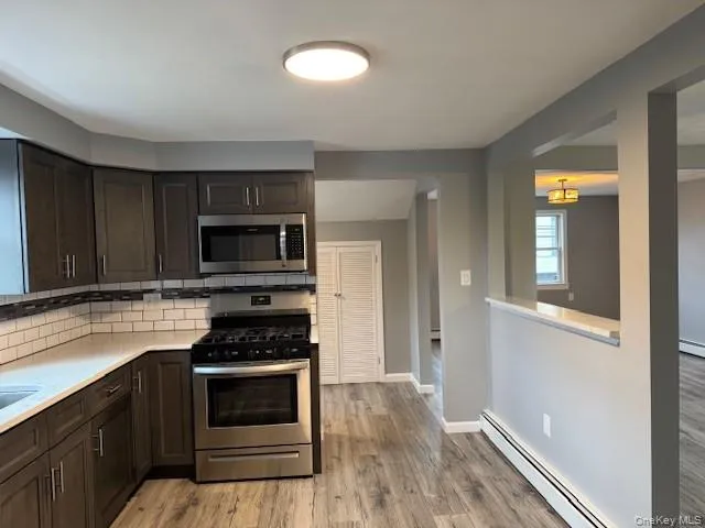 a kitchen with wooden cabinets and a stove top oven
