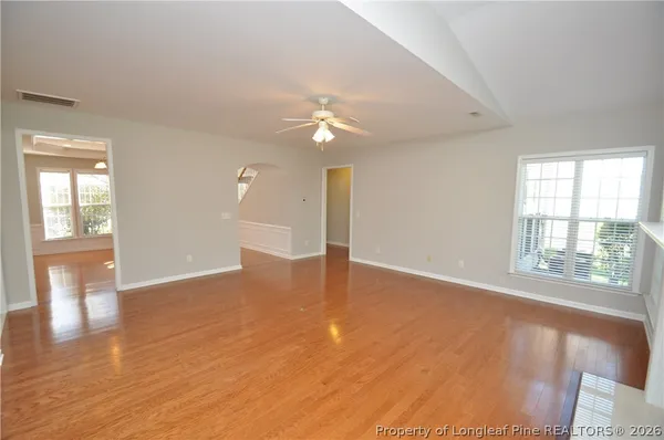 wooden floor in an empty room with a window