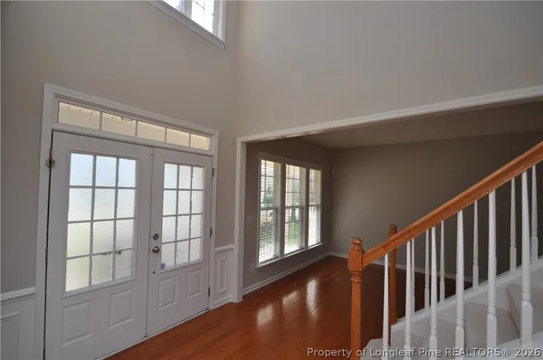 a view of an entryway with wooden floor