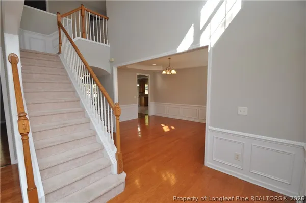a view of staircase with white walls and railing