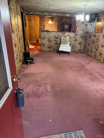 a backyard of a house with large trees and covered with snow