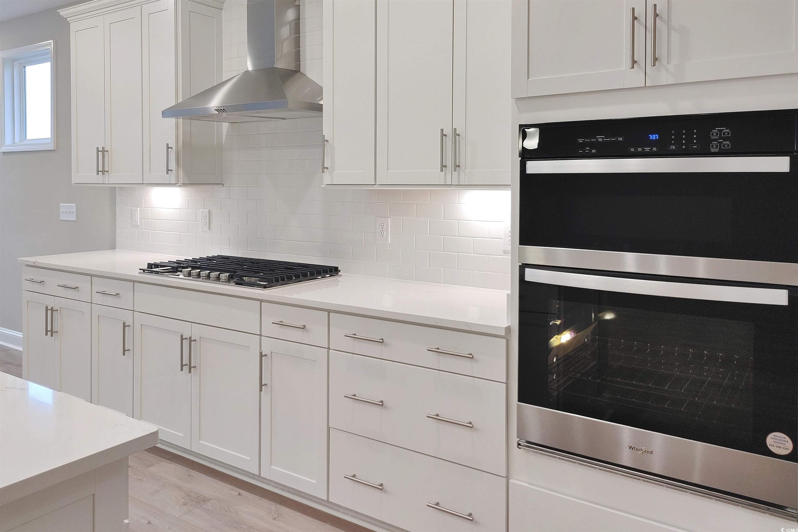 1604 Littleleaf Loop North Myrtle Beach, SC 29582 - Photo 9 of 40 Kitchen featuring wall chimney range hood, light h
