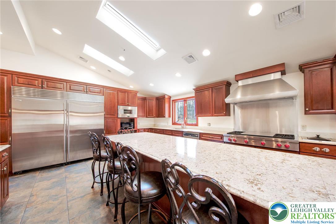 374 Packer Drive Weatherly, PA 18255 - Photo 11 of 33 a kitchen with stainless steel appliances granite countertop a table chairs sink and cabinets