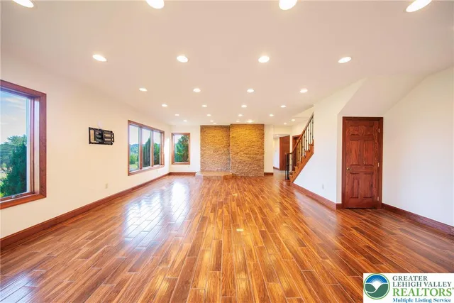 a view of empty room with wooden floor