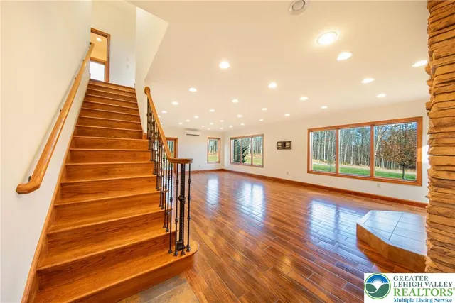 a view of entryway and hall with wooden floor