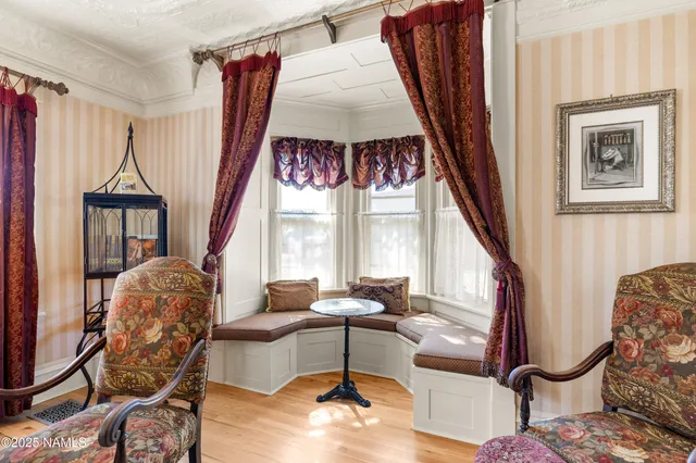 a kitchen with stainless steel appliances granite countertop stove a sink dishwasher and white cabinets with wooden floor