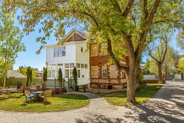a bathroom with a granite countertop sink vanity mirror and a shower