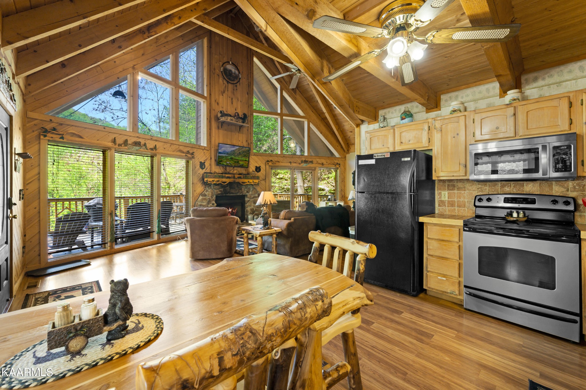 3138 North Clear Fork Road Sevierville, TN 37862 - Photo 11 of 35 a kitchen with stainless steel appliances granite countertop a stove a refrigerator a oven with a dining table and chairs