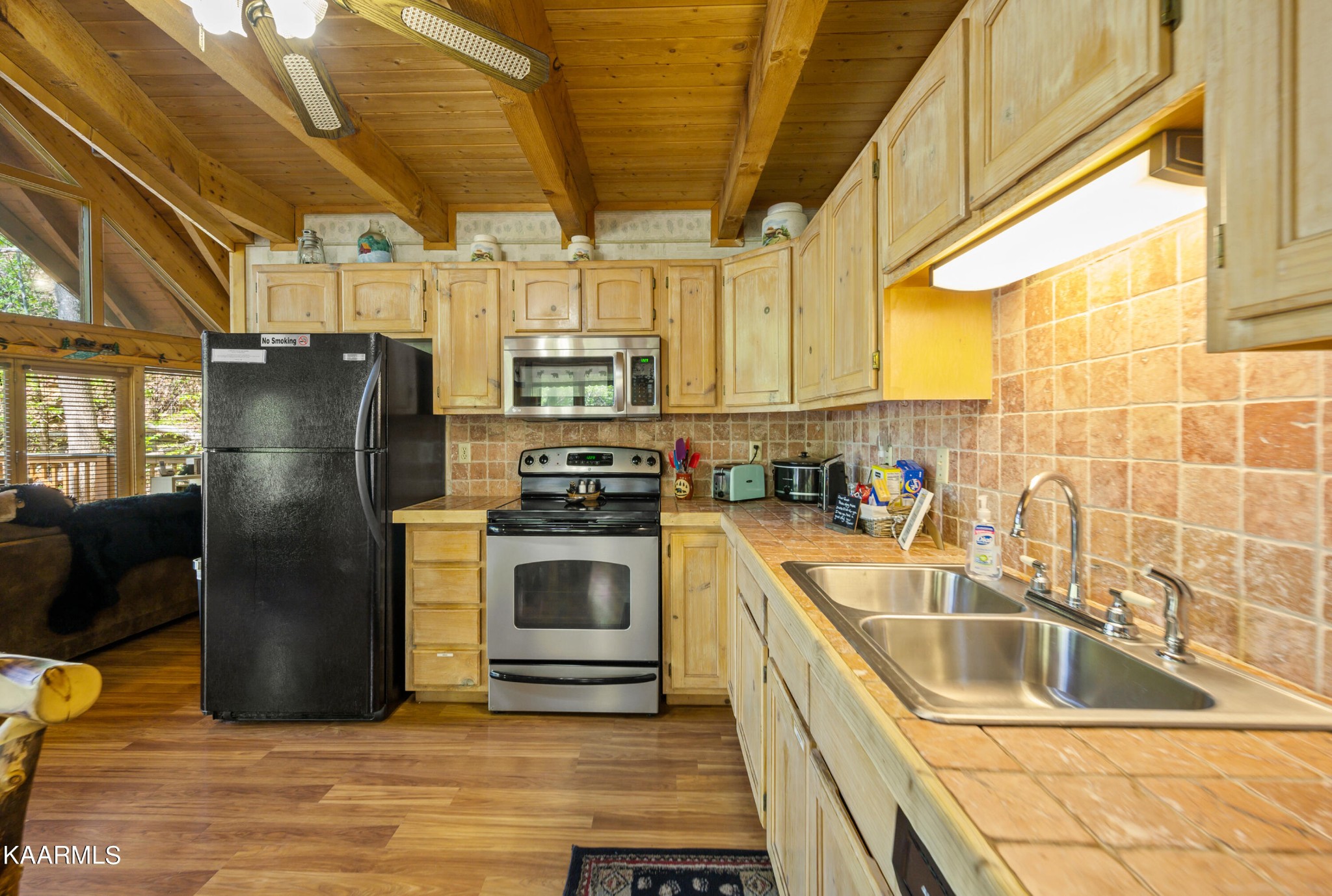 3138 North Clear Fork Road Sevierville, TN 37862 - Photo 15 of 35 a kitchen with stainless steel appliances a refrigerator a sink a stove and a refrigerator