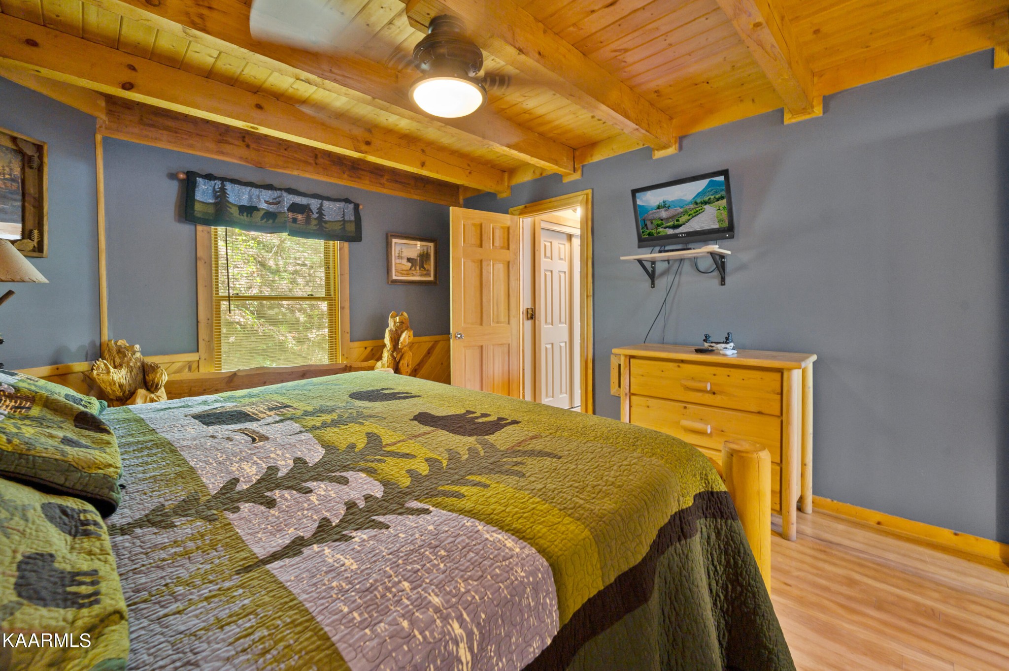 3138 North Clear Fork Road Sevierville, TN 37862 - Photo 20 of 35 a bedroom with a bed and a dresser next to a window