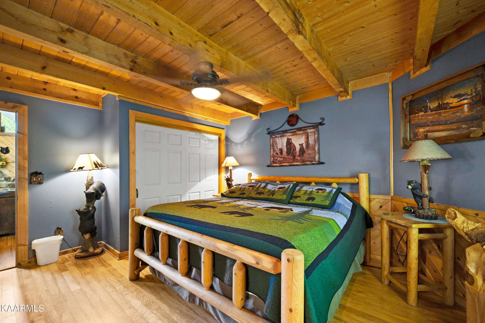 3138 North Clear Fork Road Sevierville, TN 37862 - Photo 21 of 35 a bedroom with a bed a wall painting and a lamp