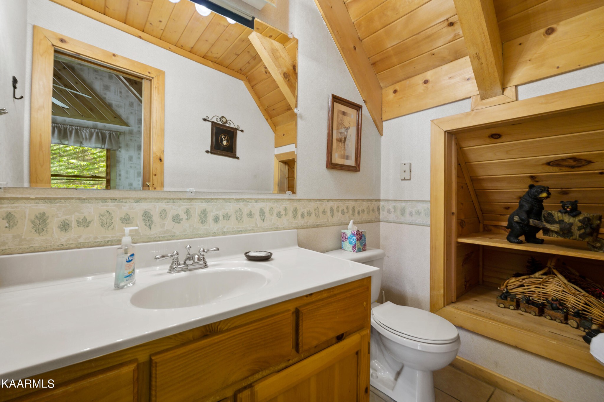3138 North Clear Fork Road Sevierville, TN 37862 - Photo 31 of 35 a bathroom with a sink and a mirror