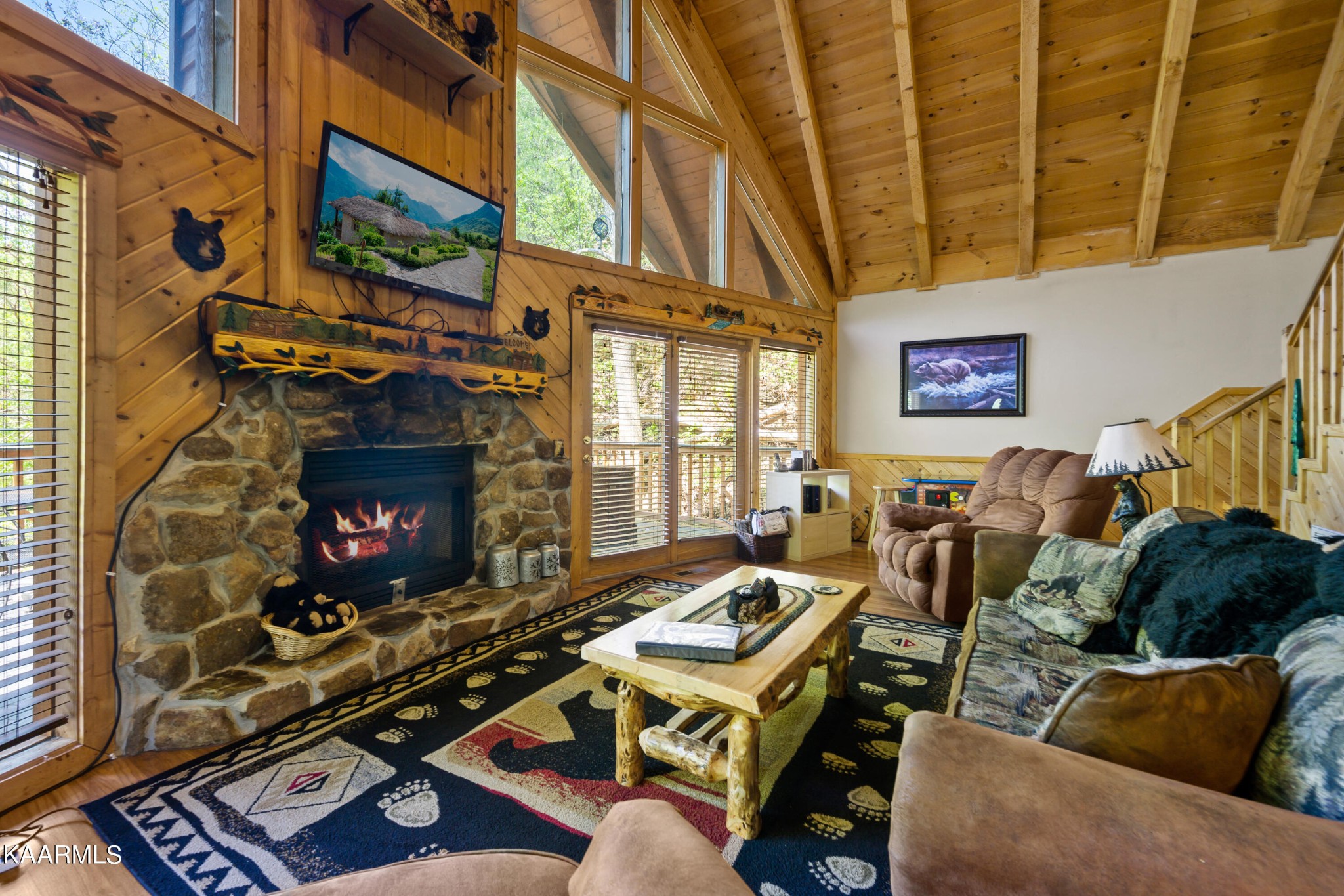 3138 North Clear Fork Road Sevierville, TN 37862 - Photo 6 of 35 a living room with furniture a fireplace and a flat screen tv