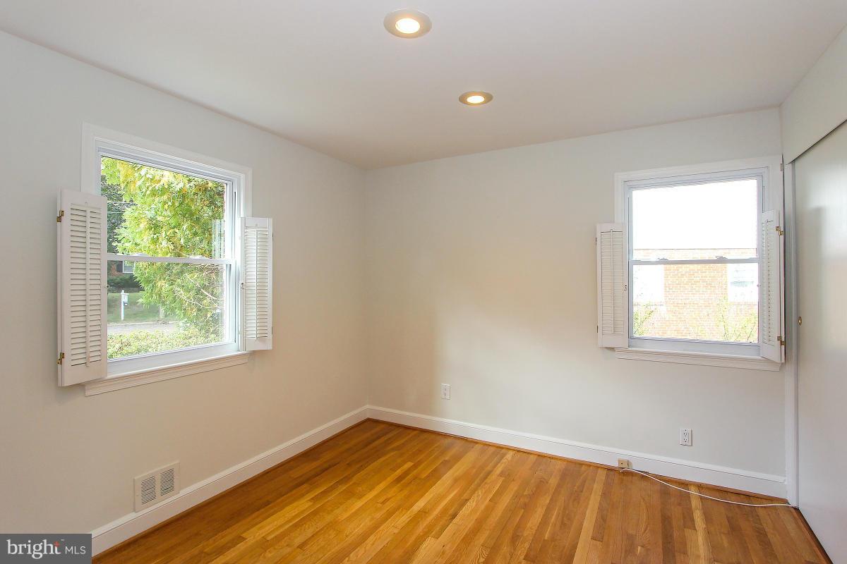 505 Kerwin Court Silver Spring, MD 20901 - Photo 14 of 27 a view of an empty room with wooden floor and a window