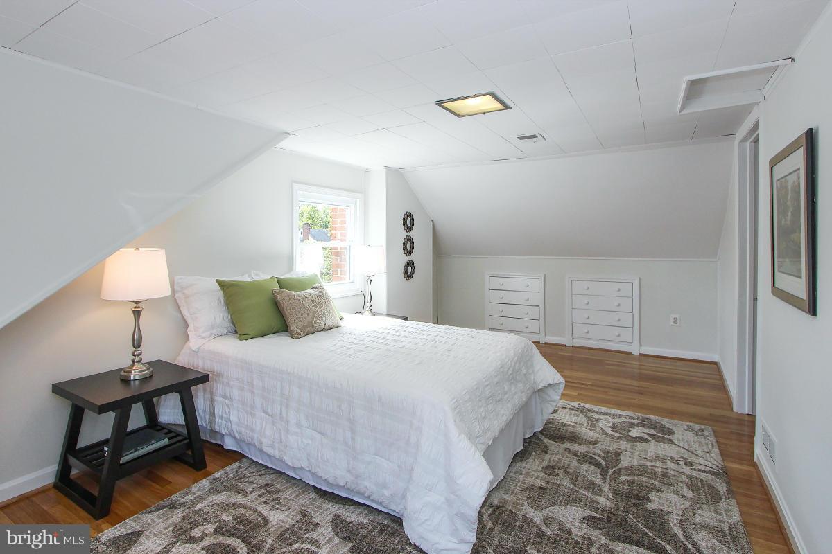 505 Kerwin Court Silver Spring, MD 20901 - Photo 21 of 27 a bedroom with a bed and a lamp on table
