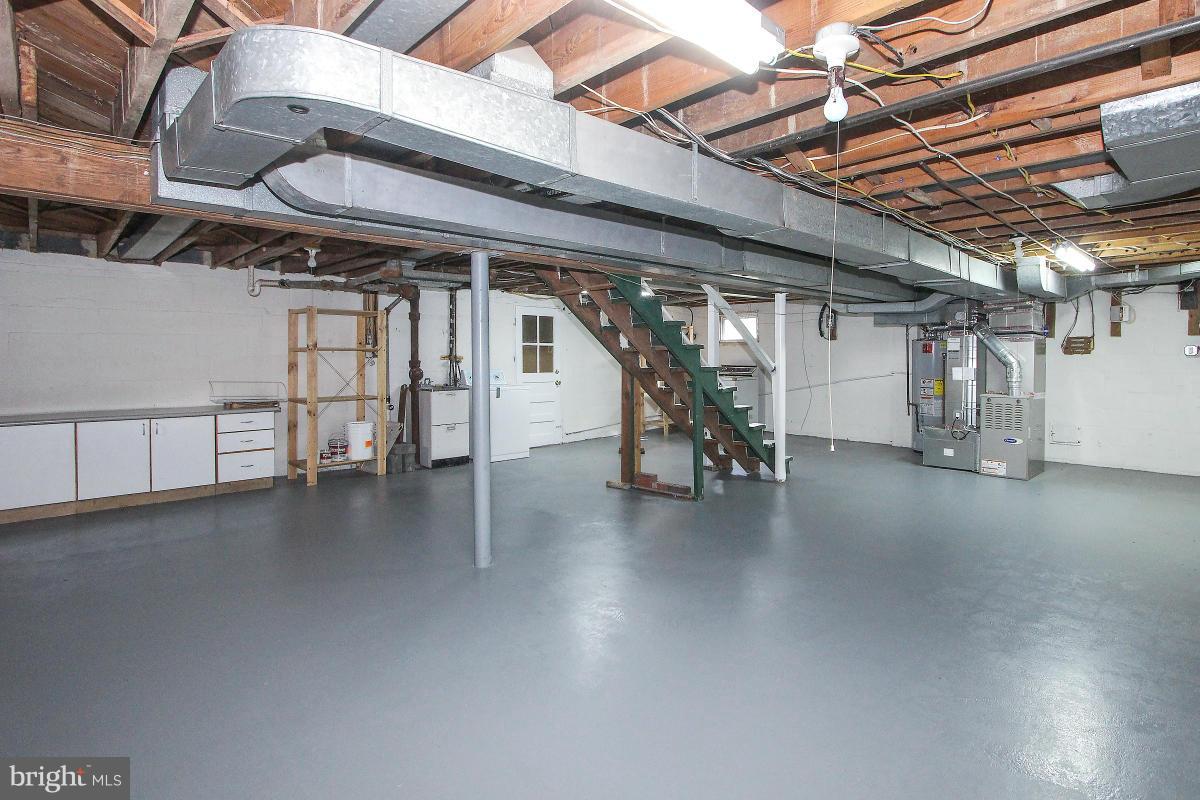 505 Kerwin Court Silver Spring, MD 20901 - Photo 24 of 27 a view of a water heater room with wooden floor