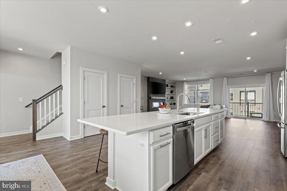 44614 Wolfhound Square Ashburn, VA 20147 - Photo 20 of 48 a kitchen with a sink and wooden floor