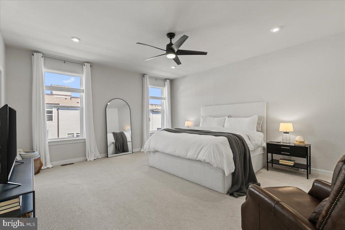 44614 Wolfhound Square Ashburn, VA 20147 - Photo 25 of 48 a bedroom with a bed and a chandelier