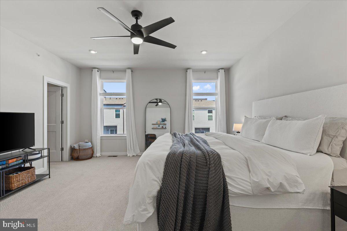 44614 Wolfhound Square Ashburn, VA 20147 - Photo 26 of 48 a bedroom with a bed and a flat screen tv