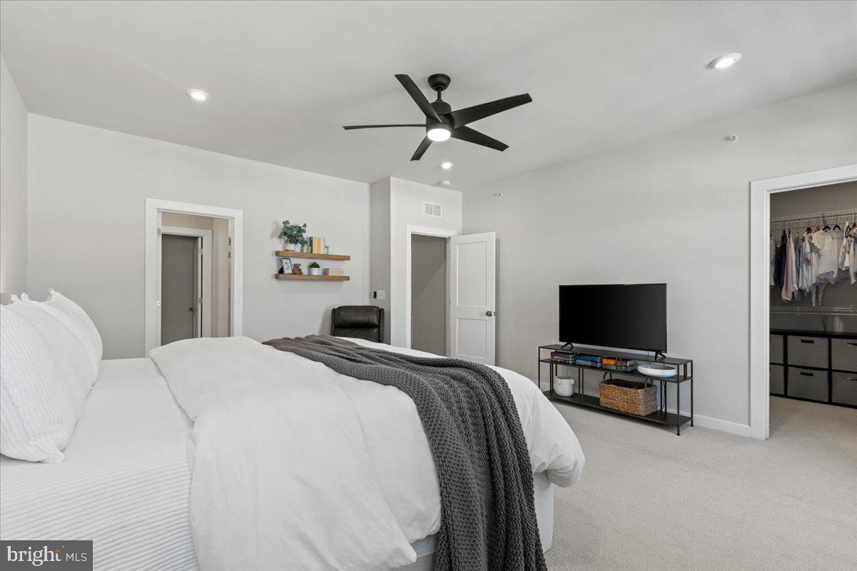 44614 Wolfhound Square Ashburn, VA 20147 - Photo 27 of 48 a bedroom with a bed and a flat screen tv