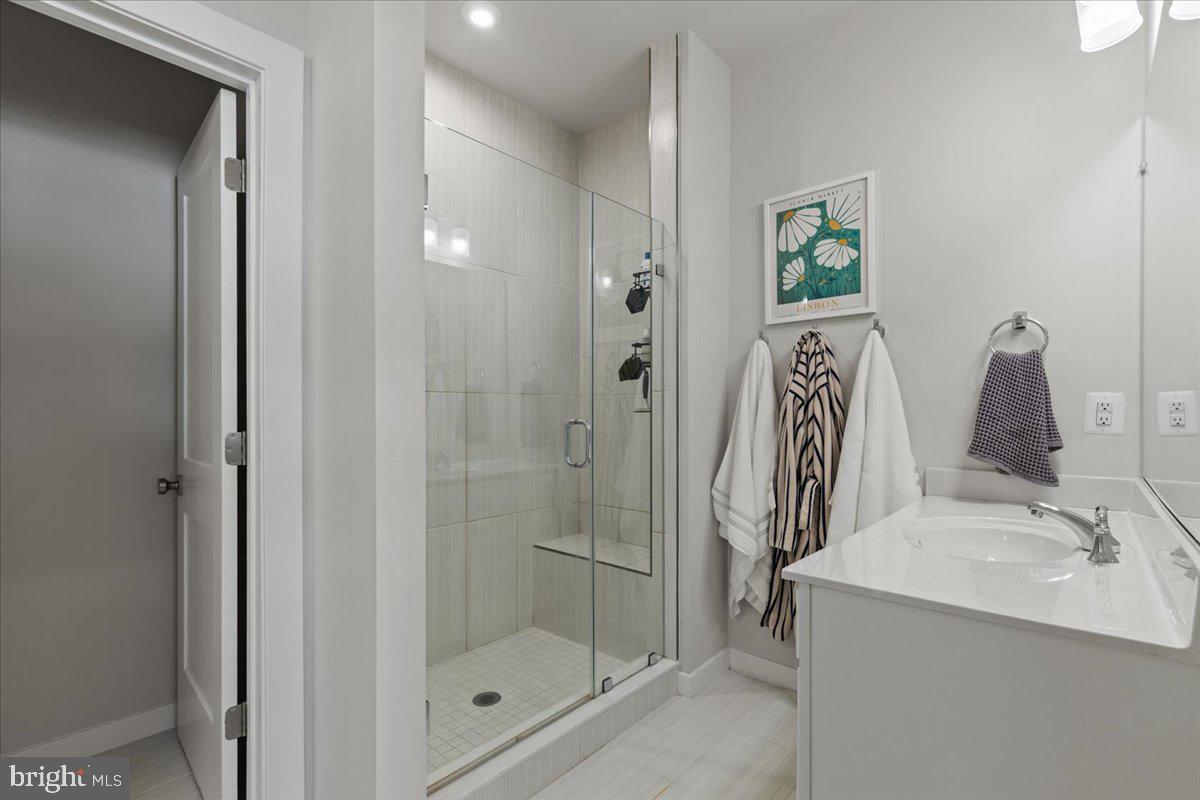 44614 Wolfhound Square Ashburn, VA 20147 - Photo 28 of 48 a bathroom with a shower and a sink