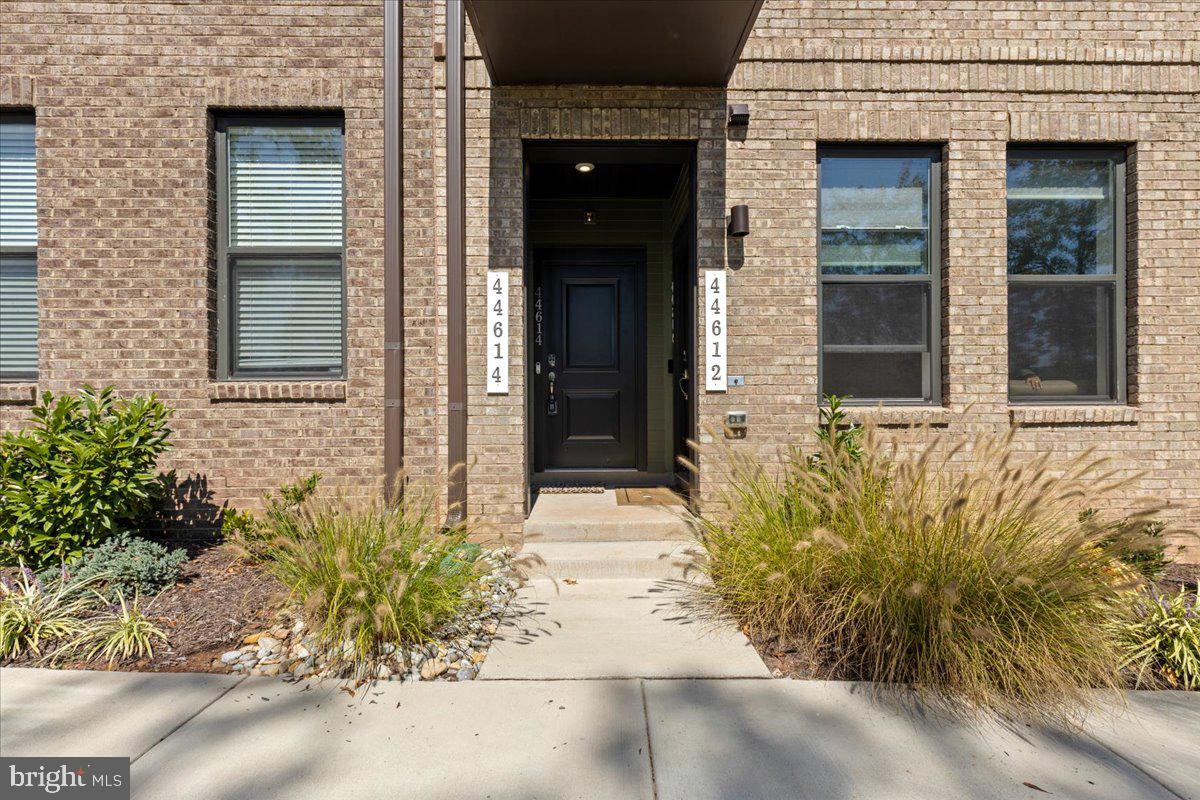 44614 Wolfhound Square Ashburn, VA 20147 - Photo 3 of 48 front view of a brick house with a large window