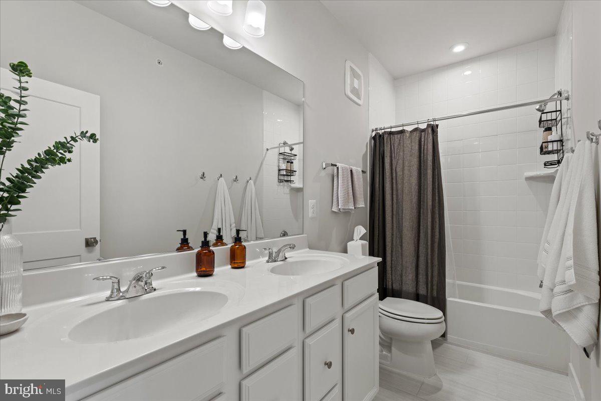 44614 Wolfhound Square Ashburn, VA 20147 - Photo 37 of 48 a bathroom with double vanity sink toilet and shower