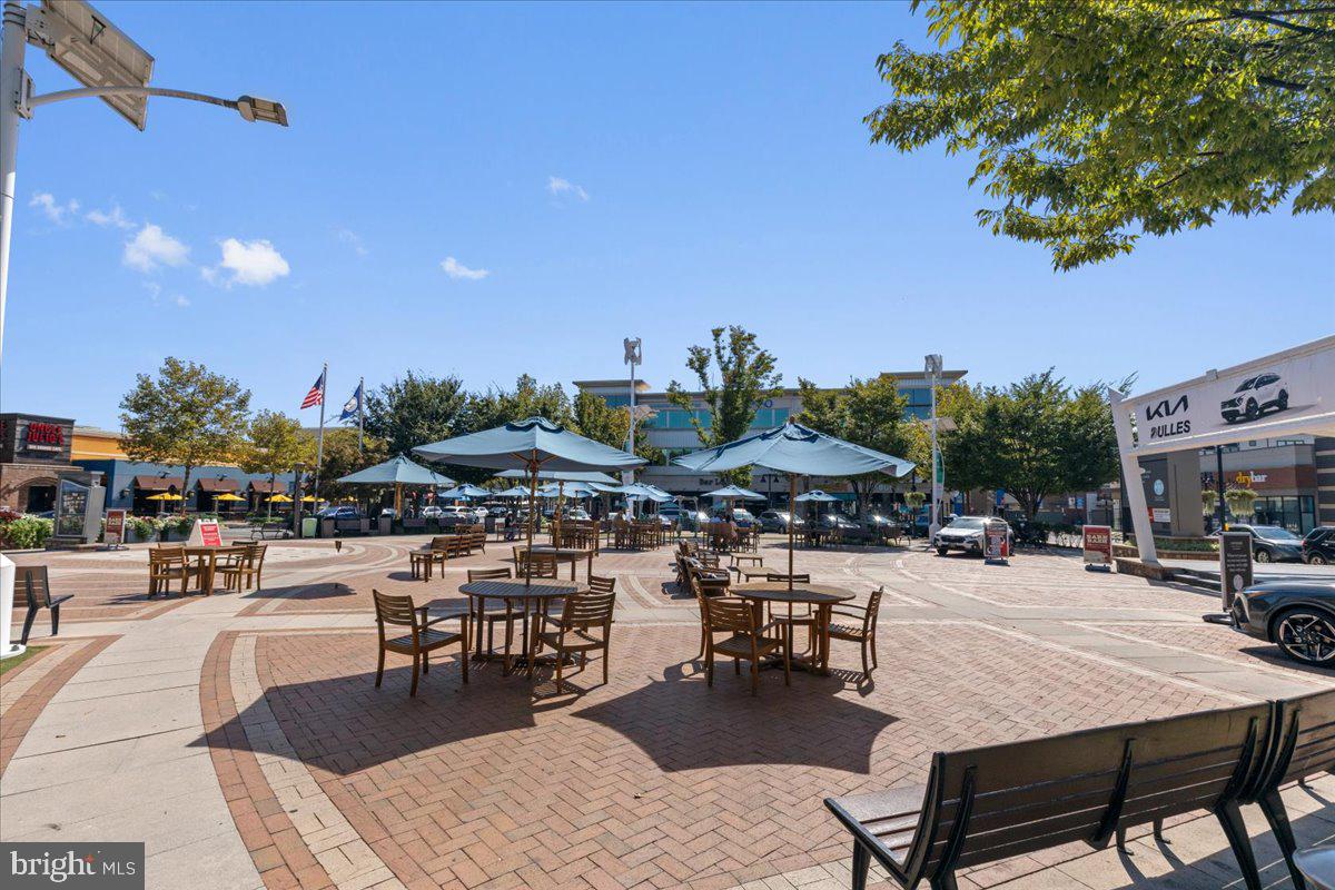 44614 Wolfhound Square Ashburn, VA 20147 - Photo 45 of 48 a view of a patio with dining table and chairs