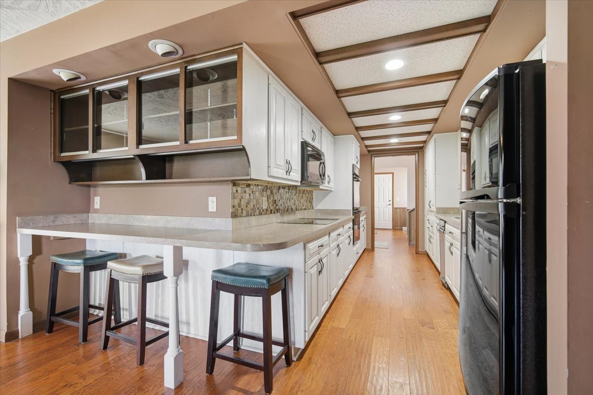504 South School Street Minier, IL 61759 - Photo 13 of 46 a kitchen with a table chairs refrigerator and cabinets