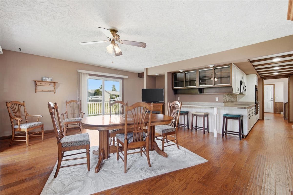 504 South School Street Minier, IL 61759 - Photo 15 of 46 a dining room with wooden floor a chandelier a glass table and chairs
