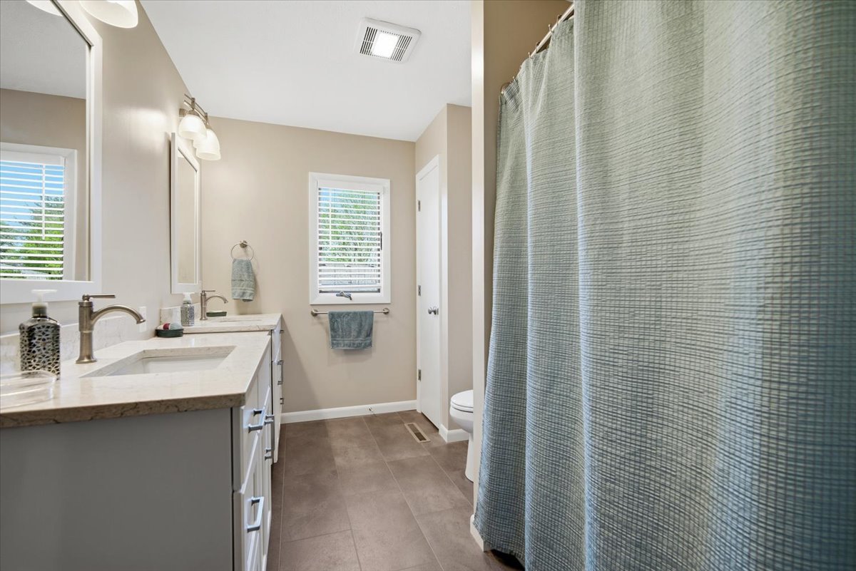 504 South School Street Minier, IL 61759 - Photo 21 of 46 a bathroom with a sink a toilet and shower