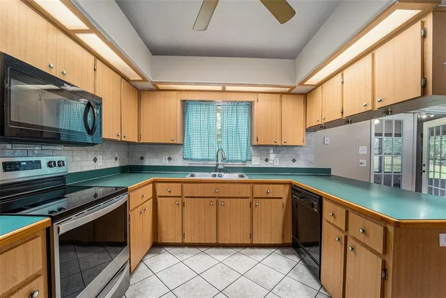 a kitchen with stainless steel appliances granite countertop a sink stove and cabinets