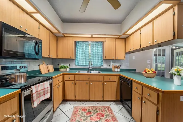 a kitchen with a sink cabinets and window